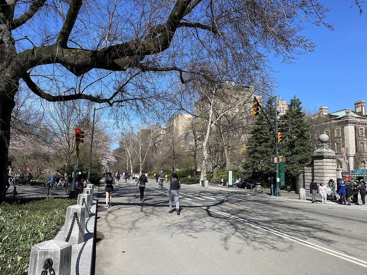 Runners at Engineers' Gate in Central Park on a sunny day